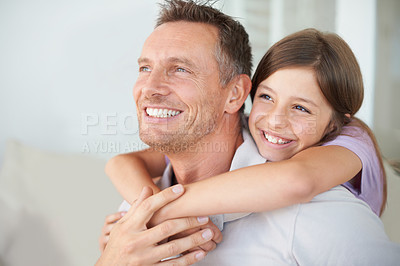 Buy stock photo A cute little girl embracing her mature dad from behind