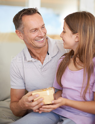 Buy stock photo Smile, father and daughter on sofa with gift box for birthday, achievement and celebration in family home. Giving, happy girl child and dad on couch for present, gratitude and surprise in living room