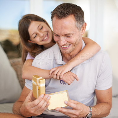 Buy stock photo A young girl giving her dad a gift for father's day
