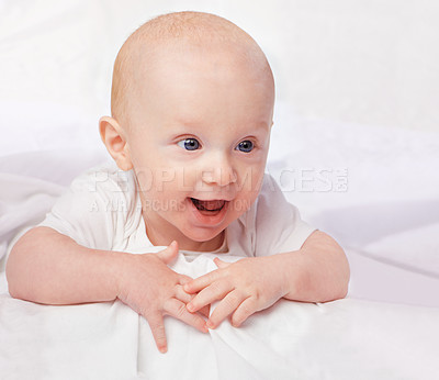 Buy stock photo Baby, excited and smile with laying on bed for curiosity, child development and relax on bed at house. Adorable, kid and cute infant in home for playful, laugh and fun with happiness in nursery