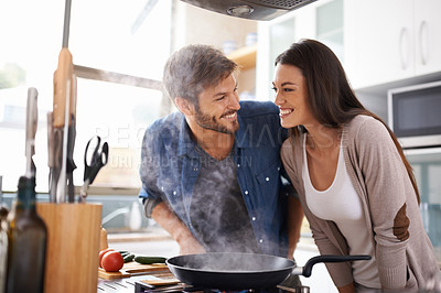 Buy stock photo Food, love and happy couple in kitchen cooking, smile and preparing lunch in their home together. Dinner, date and man with woman excited, hungry and cheerful for meal preparation in their apartment