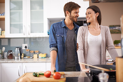Buy stock photo Love, food and happy couple in kitchen cooking, smile and preparing lunch in their home together. Dinner, date and man with woman for natural nutrition and vegan meal prep in their apartment