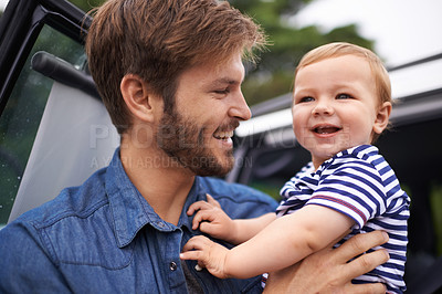 Buy stock photo Father, baby and love in embrace, outdoors and support or relax in nature and single parent. Daddy, son and affection for bonding in childhood, happy and security in hug or smile on face in nature