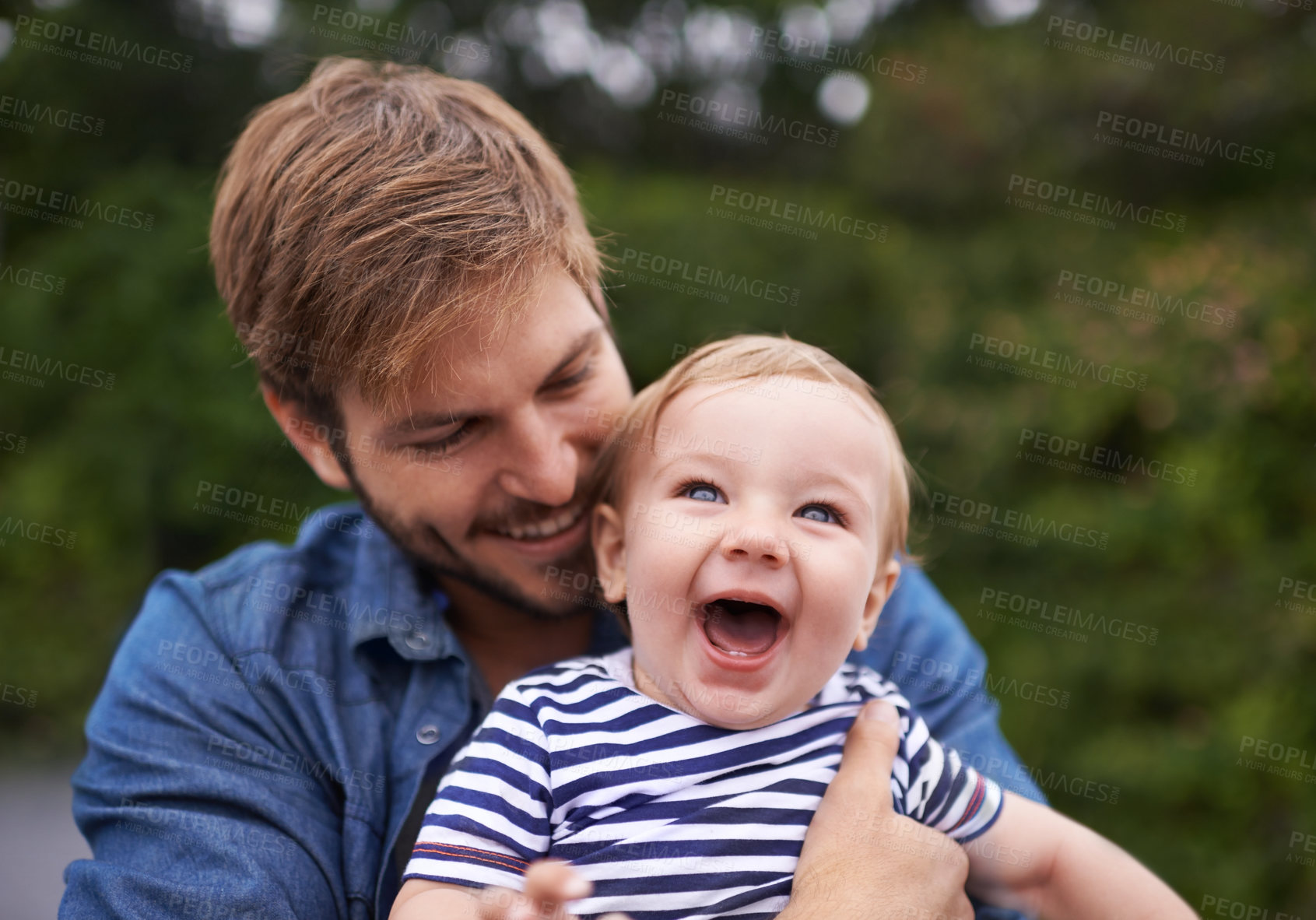 Buy stock photo Father, laughing and baby in park to hug for playing, happiness and bonding in a family in nature. Relax, boy or face of a toddler with dad, love or smile for child development, wellness or growth 