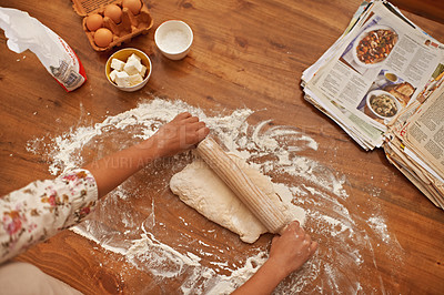 Buy stock photo Dough, recipe and hands with rolling pin on table, above baking in kitchen and closeup on process in bakery. Person, prepare and press bread with flour and meal prep with information guide in book