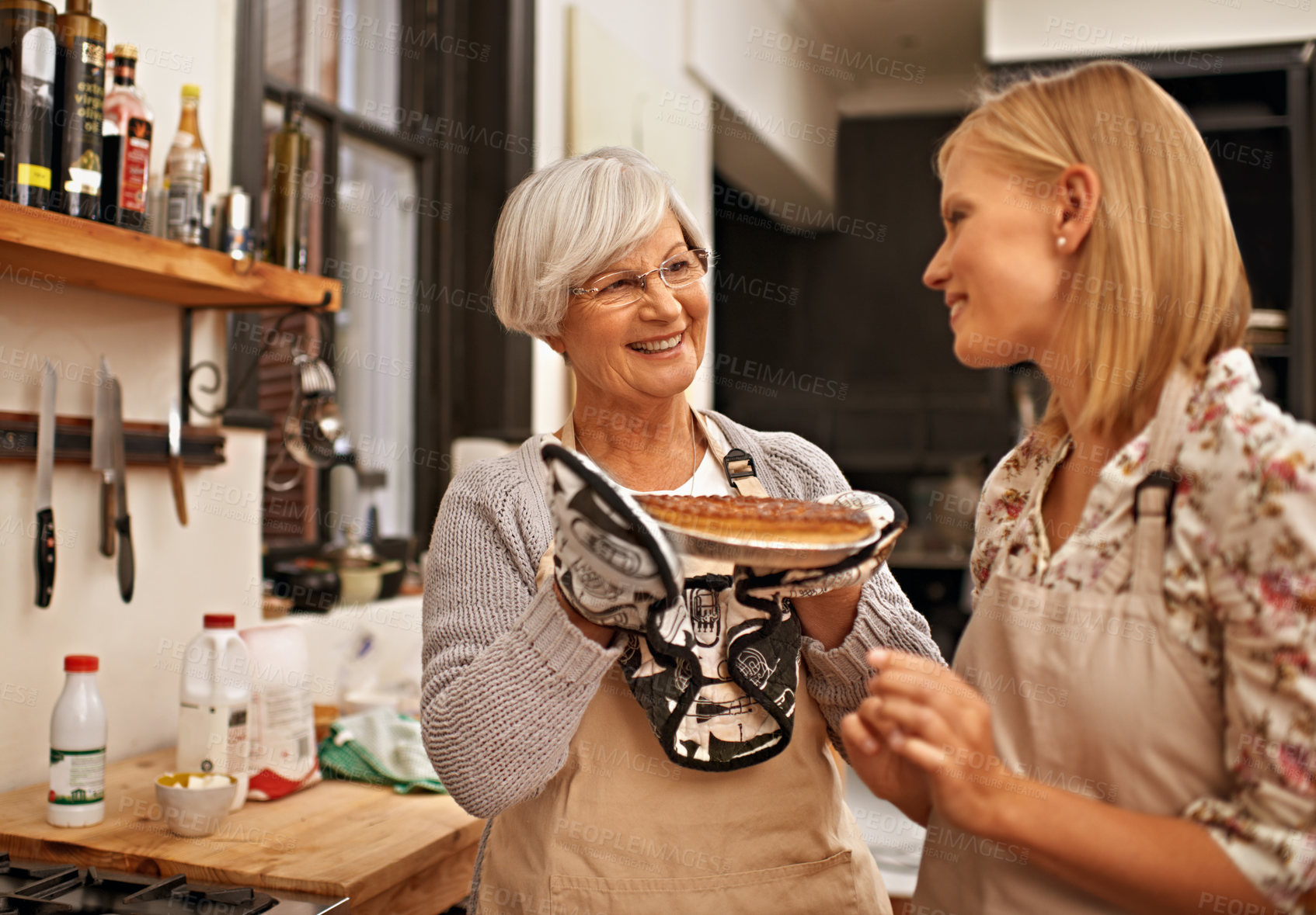 Buy stock photo Family, smile and senior mother baking with daughter in kitchen of home together for pastry preparation. Food, cooking or pie with happy parent and woman in apartment looking proud of recipe