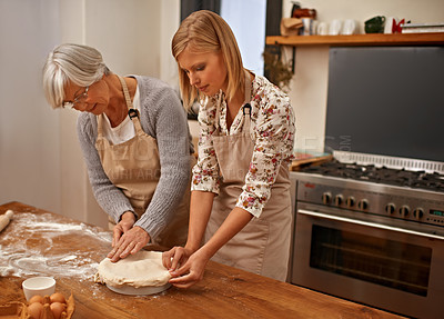 Buy stock photo Mature, mother and baking in kitchen with woman, helping with dinner and meal prep together. Senior, mom and person in home learning about family recipe with flour, dough and prepare pie in dish