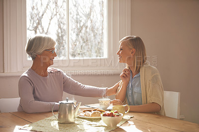 Buy stock photo House, woman and daughter visit mom in kitchen with food for breakfast, tea and snacks with senior. Female person, smile and happiness with mother in family home, elderly and girl in dining room