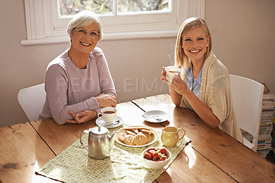 Buy stock photo Portrait, happy woman and elderly mother drinking tea at breakfast, bonding and smile in house. Face, senior mom and adult with coffee cup at table, food and family eating biscuits at home together