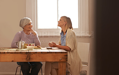 Buy stock photo Family, happy woman and senior mother drinking coffee at breakfast, bonding and smile. Elderly mom, adult and tea cup at table for conversation, love and daughter eating cookies at home together