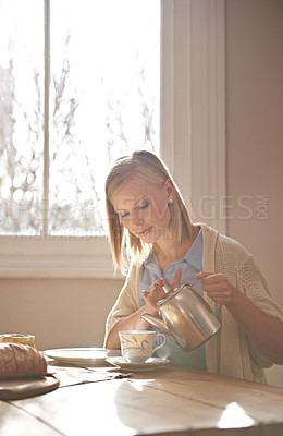 Buy stock photo Woman, pouring and tea in home for morning, calm routine and drink on table. Girl, relax and coffee break with food, snacks or teapot in hands for breakfast preparation on holiday or vacation