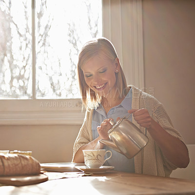 Buy stock photo Pouring, tea and happy woman in home for morning, calm routine and drink on table. Girl, relax and coffee break with food, snacks or teapot in hands for breakfast preparation on holiday or vacation