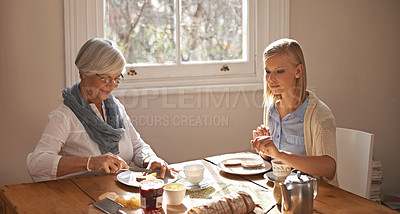 Buy stock photo Happy woman, senior mother and eating breakfast, drinking tea and bonding at home together. Smile, elderly mom and daughter with coffee cup at table, food and family with healthy cheese on bread
