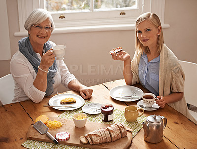 Buy stock photo Portrait, happy woman and senior mother drinking tea at breakfast, bonding and smile in house. Face, elderly mom and adult with coffee cup at table, food and family eating bread at home together