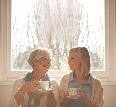 Buy stock photo Family, happy woman and senior mother drinking coffee at breakfast, talking and smile. Laughing, elderly mom and daughter with tea cup, conversation and listening to funny story at home together