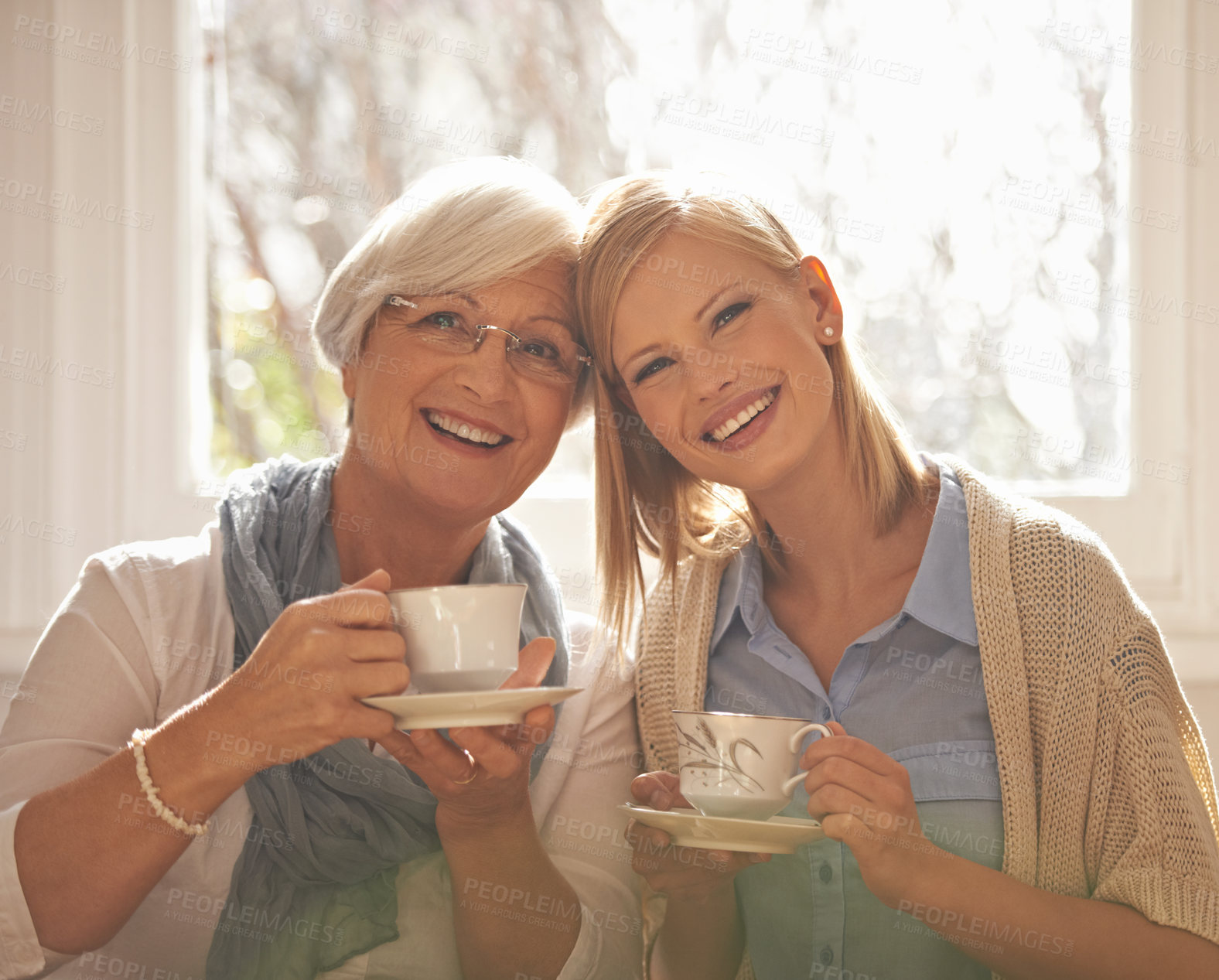 Buy stock photo Portrait, smile and woman with senior mother drinking tea at breakfast in the morning, bonding and happy in house. Face, elderly mom and daughter with coffee cup, love and family at home together