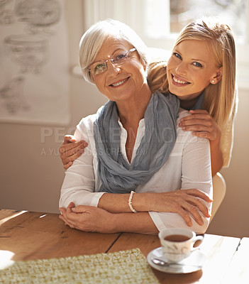 Buy stock photo Senior woman, daughter and portrait in lounge with tea for hug, visit and retirement. Elderly pensioner, grandmother and lady with smile in home for affection together with love and gesture of touch