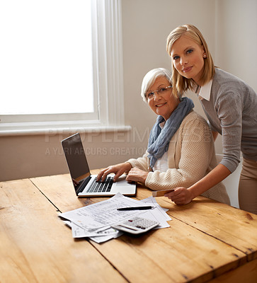 Buy stock photo A granddaughter helping her grandmother with her budget