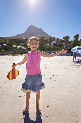 Buy stock photo Happy girl, portrait and beach with paddle bat for playful summer, holiday weekend or outdoor ball game in nature. Female person, child or kid with smile for fun sunny day or activity by the ocean