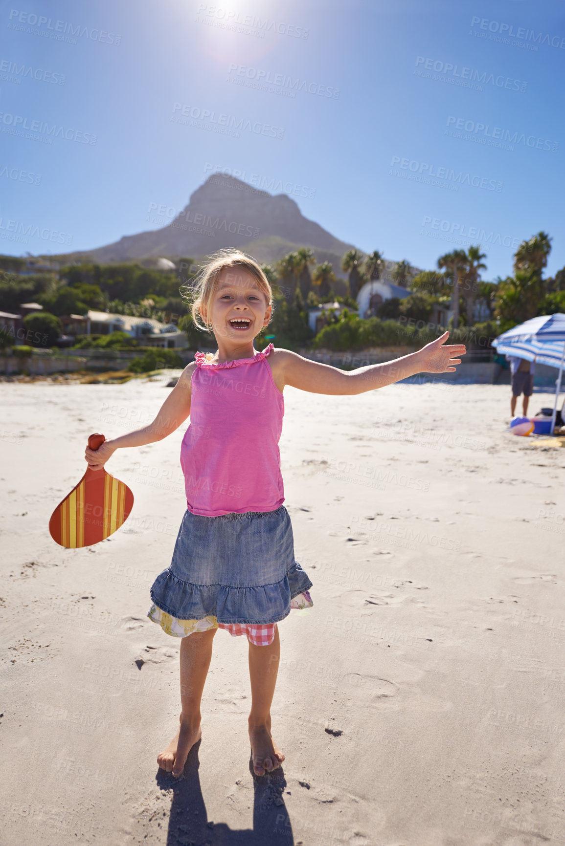 Buy stock photo Happy girl, portrait and beach with paddle bat for playful summer, holiday weekend or outdoor ball game in nature. Female person, child or kid with smile for fun sunny day or activity by the ocean