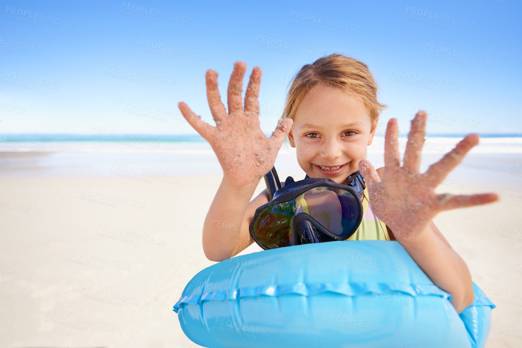 Buy stock photo Girl, portrait and hands for swimming on sand, beach and goggles or inflatable donut on holiday. Female person, child and happy on tropical vacation in outdoors, ocean and blue sky for mockup space