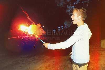 Buy stock photo Boy, night and happy in playing with fireworks on holiday for new year celebration, colors and excited. Teenager, festive season and firecracker for festival on vacation for event, happiness and fun
