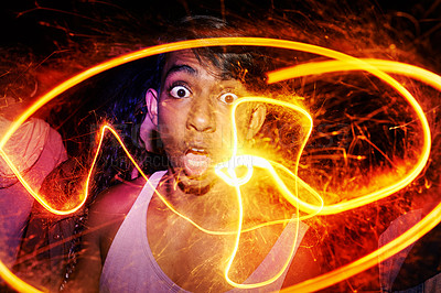 Buy stock photo Portrait, festival and man with fire art for Diwali, New Year or social event at night in India. Celebration, sparkle lights and shocked person with fireworks, smoke and flare for happy outdoor party