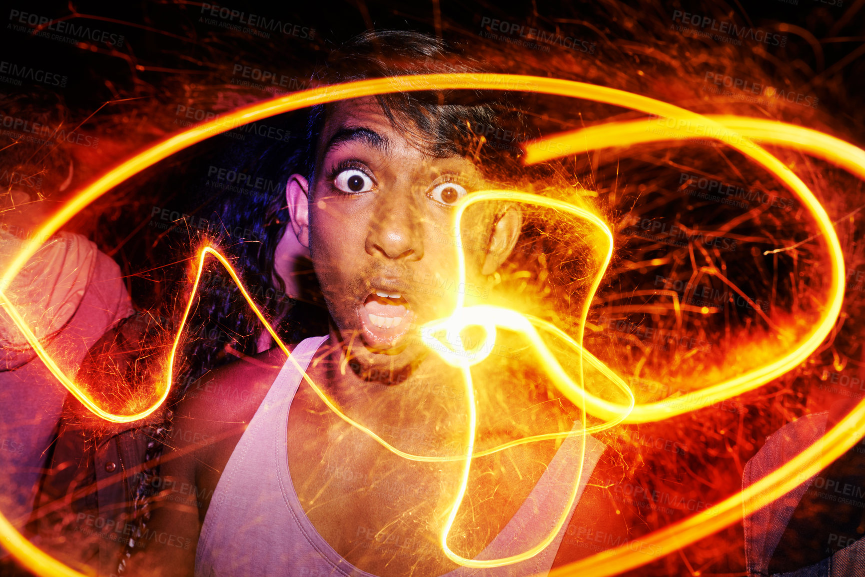 Buy stock photo Portrait, festival and man with fire art for Diwali, New Year or social event at night in India. Celebration, sparkle lights and shocked person with fireworks, smoke and flare for happy outdoor party