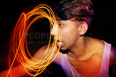 Buy stock photo Sparklers, excited and outdoor with teenage boy, funny and fireworks with happiness and evening. Person, outside or silly with New Years party or event with celebration or smile with culture or goofy