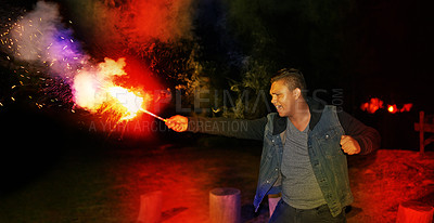 Buy stock photo Burn, night and man at festival with fireworks for Diwali, New Year or social event in India. Celebration, sparkle lights and excited person with fire art, smoke and flare for happy outdoor party