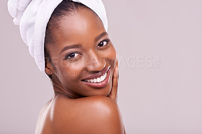 Buy stock photo Hair towel, portrait and happy black woman in studio for skincare, wellness or body care on purple background. Beauty, cleaning or hands on face of African female model with cosmetic, shine or glow