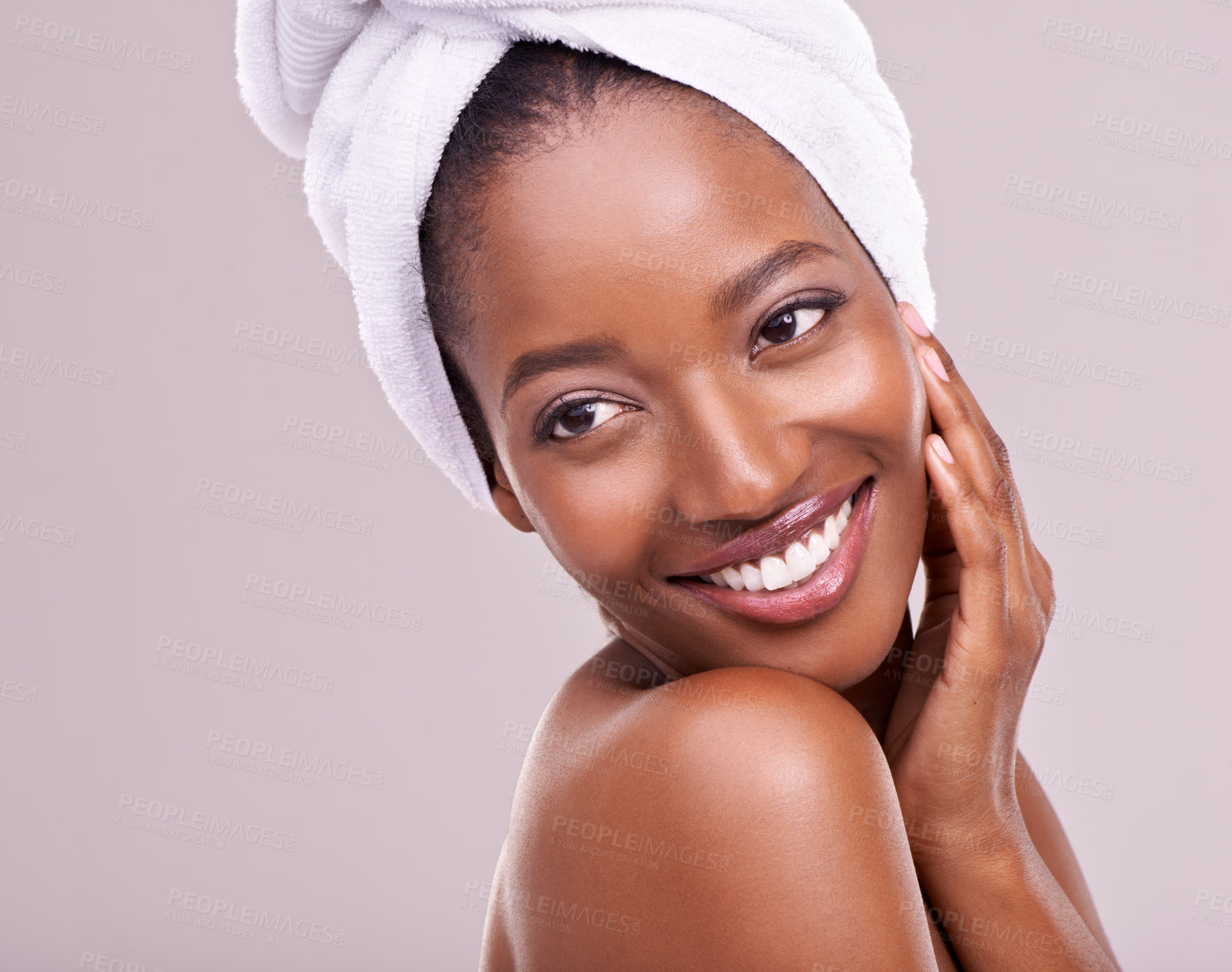 Buy stock photo Happy, woman and skin care with towel in studio for beauty, dermatology and thinking of benefits. Soft, facial and glow of young model or African person with smile for cosmetics on a white background