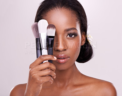 Buy stock photo Cosmetics, makeup and portrait of black woman with brush on face in studio with cosmetic application tools. Skincare, beauty and facial skin care model with luxury contour brushes on pink background.