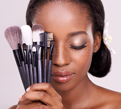 Buy stock photo Cosmetic tools, makeup and black woman with brushes, face on studio background with application tool. Skincare, beauty and cosmetics, facial skin care model with luxury contour tools and closed eyes.