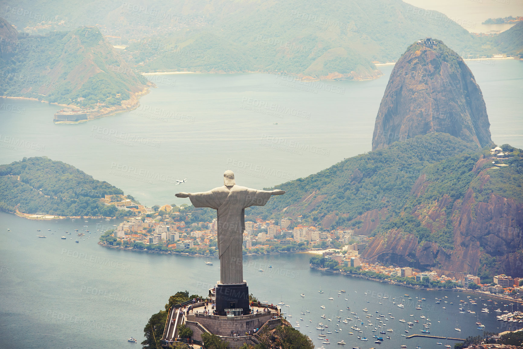 Buy stock photo Statue, monument and Christ the Redeemer on mountain for tourism, sightseeing and travel destination. Traveling, Rio de Janeiro and aerial view of symbol, sculpture and city landmark by Brazil ocean