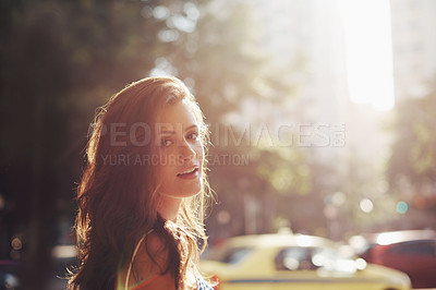 Buy stock photo Cropped shot of an attractive young woman in an urban setting
