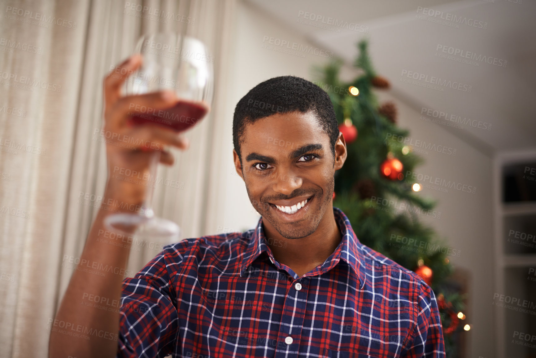 Buy stock photo Shot of a handsome young man getting into the Christmas spirit