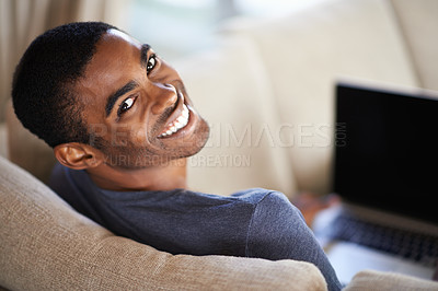 Buy stock photo Man, portrait and happy on sofa with relax for internet streaming, communication or online games in home. Student, african person and face with smile, laptop or technology in living room for research