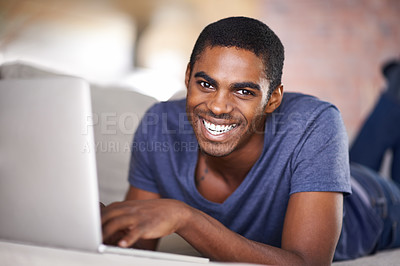 Buy stock photo Man, portrait and smile on sofa with laptop for internet streaming, communication or online games in home. Student, african person and happy with face, relax or technology in living room for research