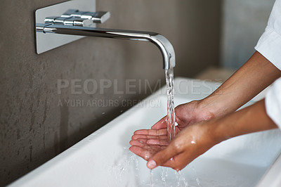 Buy stock photo Shot of a woman washing her hands under a tap