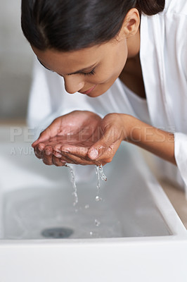 Buy stock photo Hands, water and woman cleaning face for beauty and skincare, wellness and splash in sink in bathroom. Facial, treatment and dermatology with washing for hygiene, grooming and morning routine at home