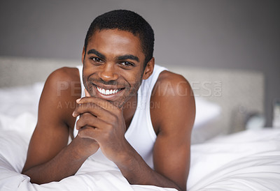 Buy stock photo Happy black man, portrait and relax with bed for morning, wakeup or holiday on break at home. Face of African male person with smile and lying in bedroom for weekend, peace or comfort at the house