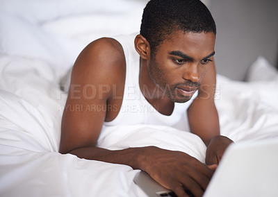 Buy stock photo Black man, bed and relax with laptop for research, social media or networking in duvet or sheets at home. African male person or freelancer typing on computer and lying in bedroom for online search