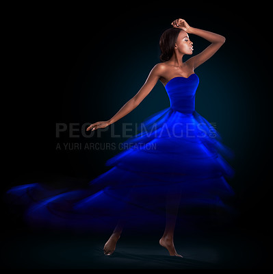 Buy stock photo Studio shot of a beautiful woman wearing a digitally enhanced dress against a black background