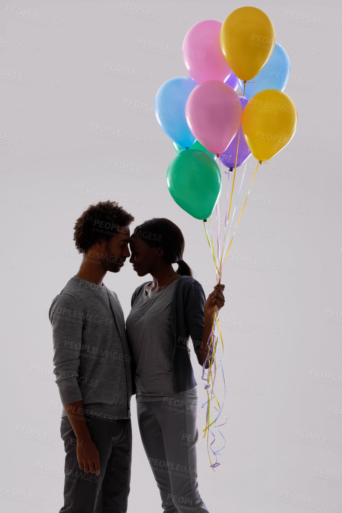 Buy stock photo Couple, silhouette and love with party balloons for celebration, event or romance on a gray studio background. Man and woman with colorful blowups of helium for date or anniversary on mockup space