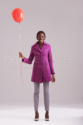 Buy stock photo Balloon, fashion and portrait of black woman in studio for birthday, celebration and present. Happy, excited and isolated person smile with inflatable for party, gift and surprise on gray background