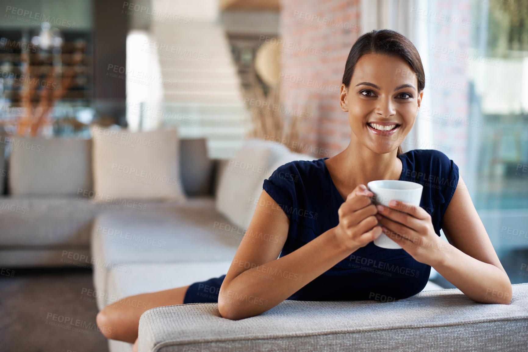 Buy stock photo Cropped shot of an attractive young woman enjoying a freshly brewed cup of coffee