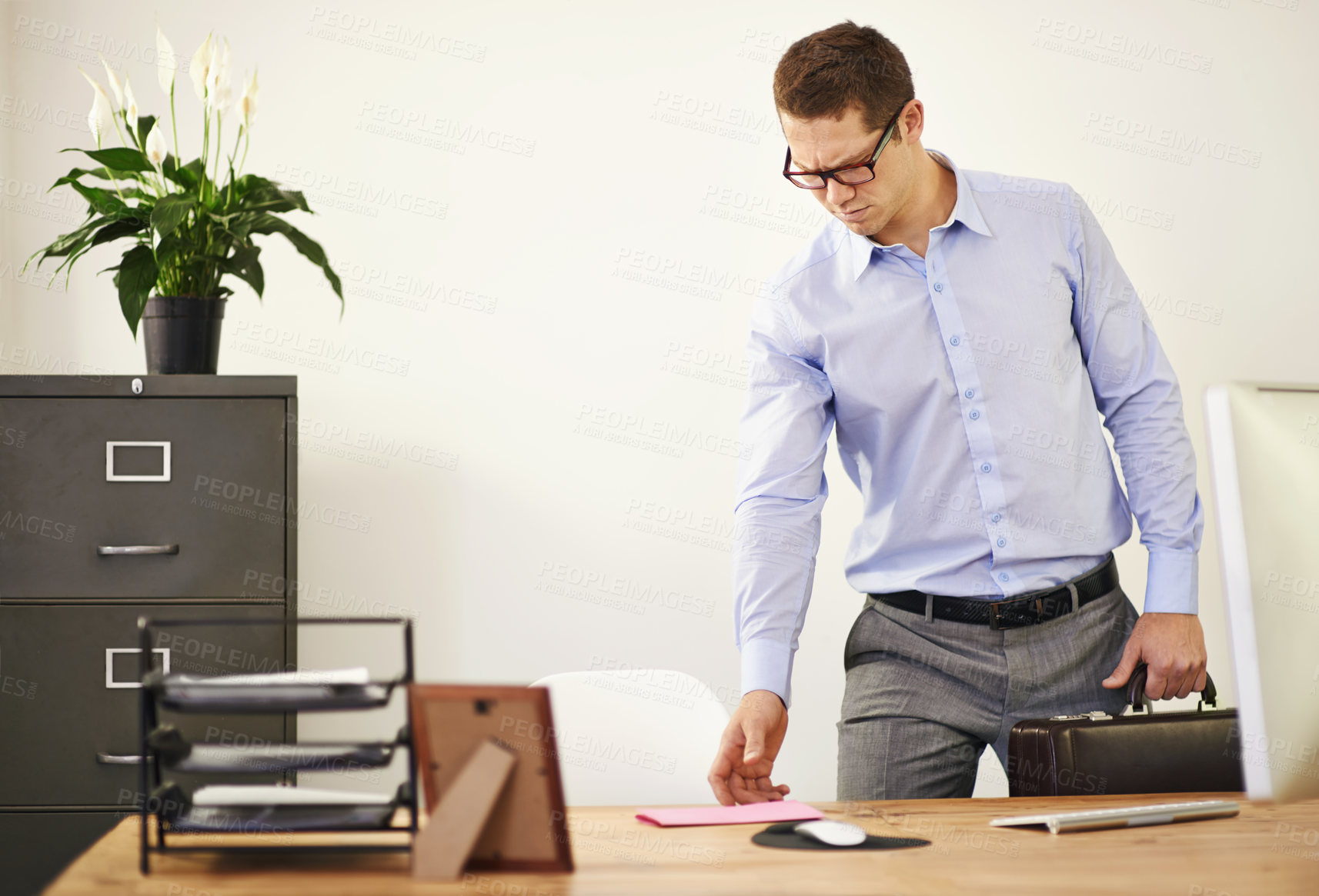 Buy stock photo Desk, letter and confused business man with briefcase in office looking worried for employment. Anxiety, doubt or frown and young employee with glasses in professional workplace for notification