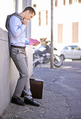 Buy stock photo Business, job loss and man on street, fired and reading letter of unemployment on city sidewalk. Anxiety, mental health and sad businessman on road with termination notice, briefcase and pink slip