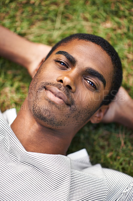 Buy stock photo Black man, relax and lying on grass while resting, sleeping and enjoy summer or nature outdoor. Male person, smile and sunshine after holiday, calm guy and happiness in garden or field or outside